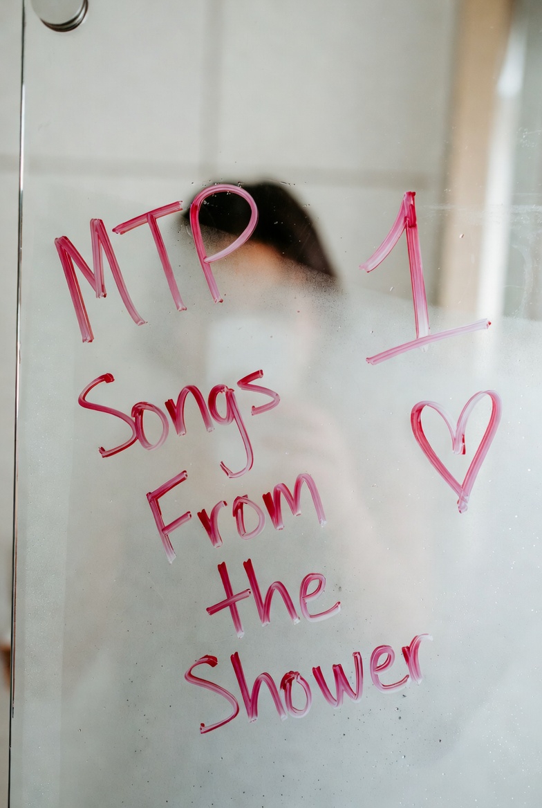 Message written on a fogged shower door about MTP songs